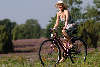 Mdchen lcheln Radfahren unter Sonnenhut blhende Heidelandschaf