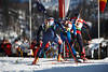 816368_Biathleten Lauf-Trio Sportbild auf Skier hintereinander im Mnner Staffelbewerb vor Publikum